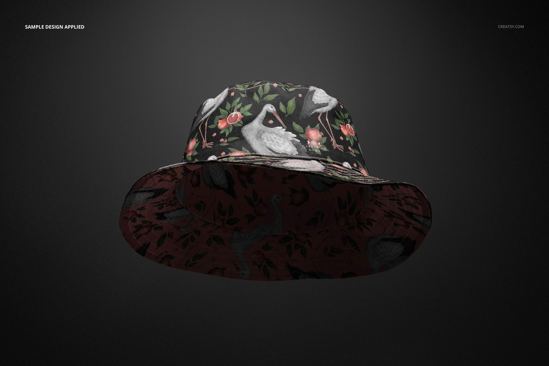 Front view of a reversible bucket hat mockup featuring a dark floral and bird pattern on a black background.