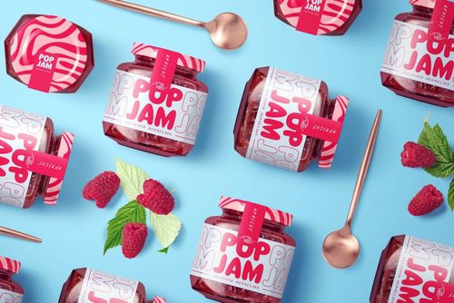 PSD mockup featuring raspberry jam jars, metal spoons, and scattered raspberries on a vibrant blue scene.