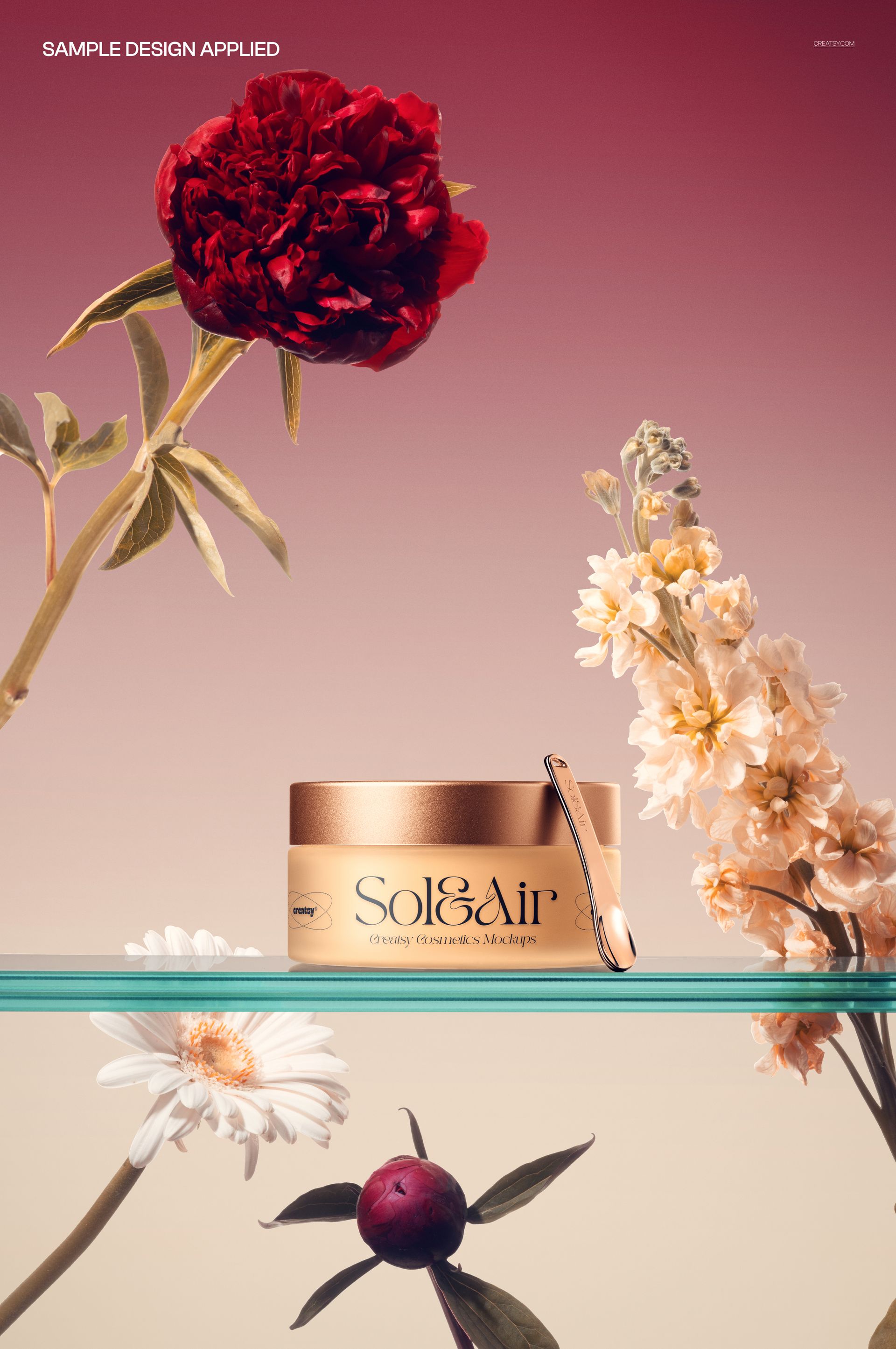 PSD mockup featuring a frosted cream jar with gold accents and spatula, set among red and white flowers.
