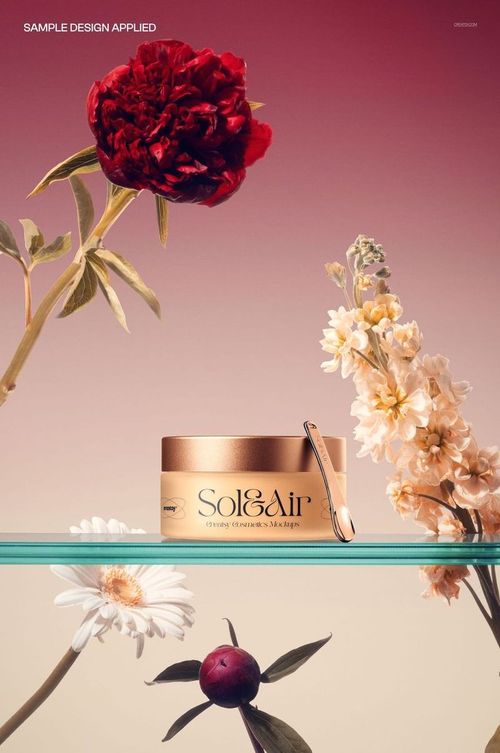 PSD mockup featuring a frosted cream jar with gold accents and spatula, set among red and white flowers.