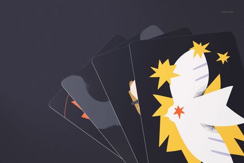 Fanned tarot cards with colorful geometric artwork, mainly in yellow, white, and orange, placed on a dark tabletop in a PSD mockup.