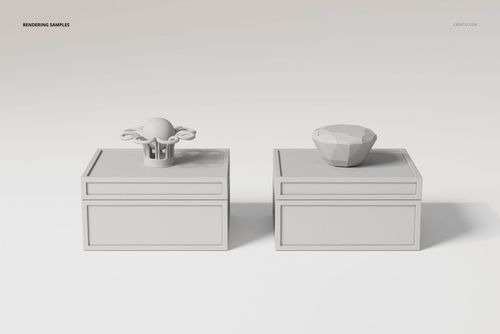 Front view of two art deco jewelry boxes in light gray, each with a distinct geometric ornament on top, set on a plain background.