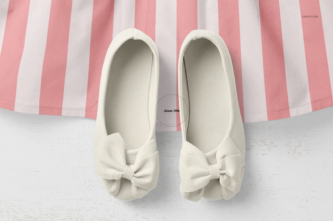 Top view of a baby dress mockup with a pink and white striped skirt and a pair of cream-colored shoes with bows.