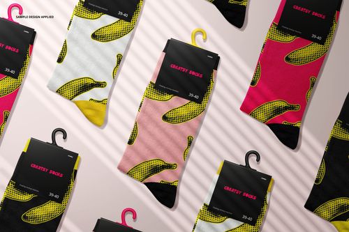 Socks mockup set featuring various colored socks with bold banana designs, displayed from a top-down perspective.