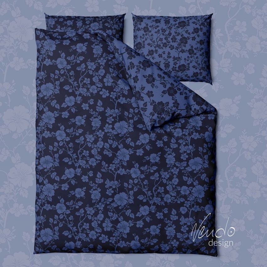 Bedding set mockup featuring a duvet cover and two pillows with a dark blue floral pattern on a matching floral background.