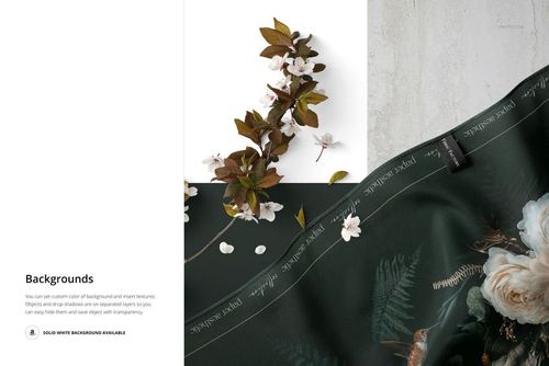 Silk scarf mockup showing detailed stitching and botanical print, displayed with small white flowers and leaves.