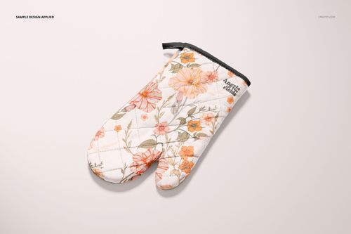 Single oven mitt mockup featuring a botanical design in warm tones, displayed flat against a neutral surface.