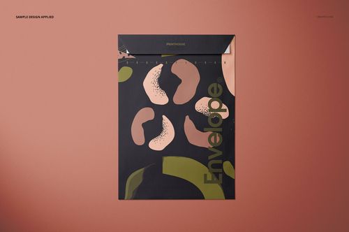 Front view of a square envelope mockup with abstract green and pink patterns on a dark background, set on a brown surface.