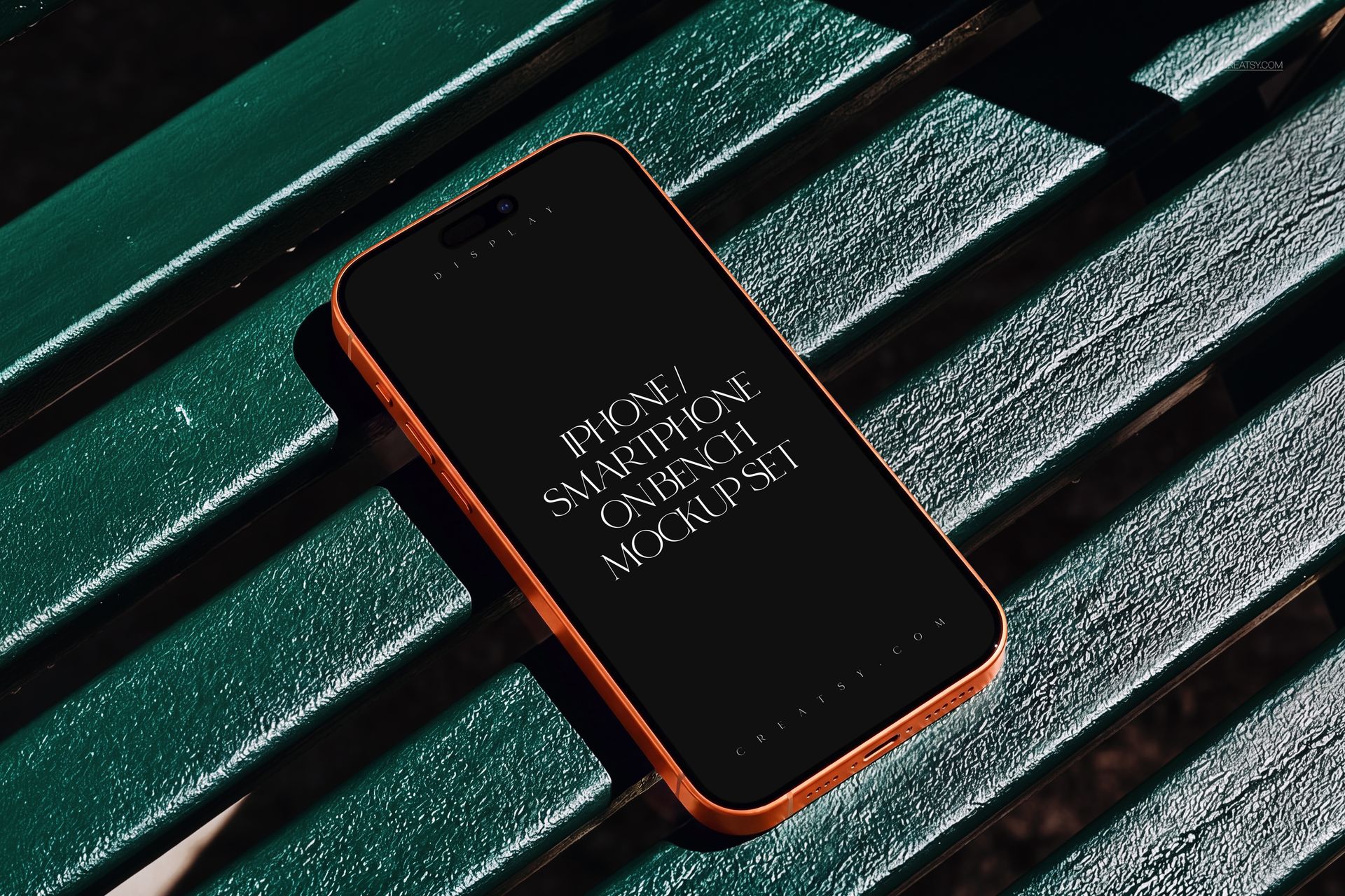 iPhone smartphone with a black screen lying on a green park bench, shown in a close-up perspective mockup.