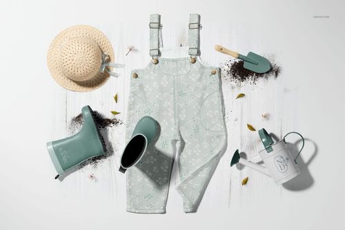 Dungarees mockup with pastel floral print, displayed with rain boots, straw hat, watering can, and gardening tools.