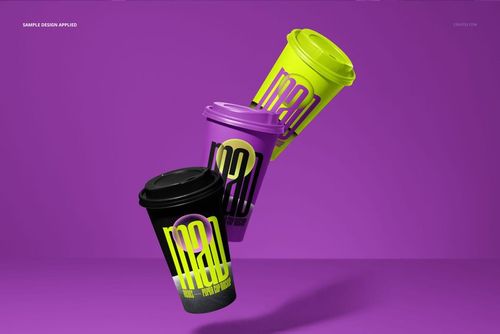 PSD mockup featuring trio of paper cups in vibrant black, purple, and yellow, displayed on a plain purple backdrop.
