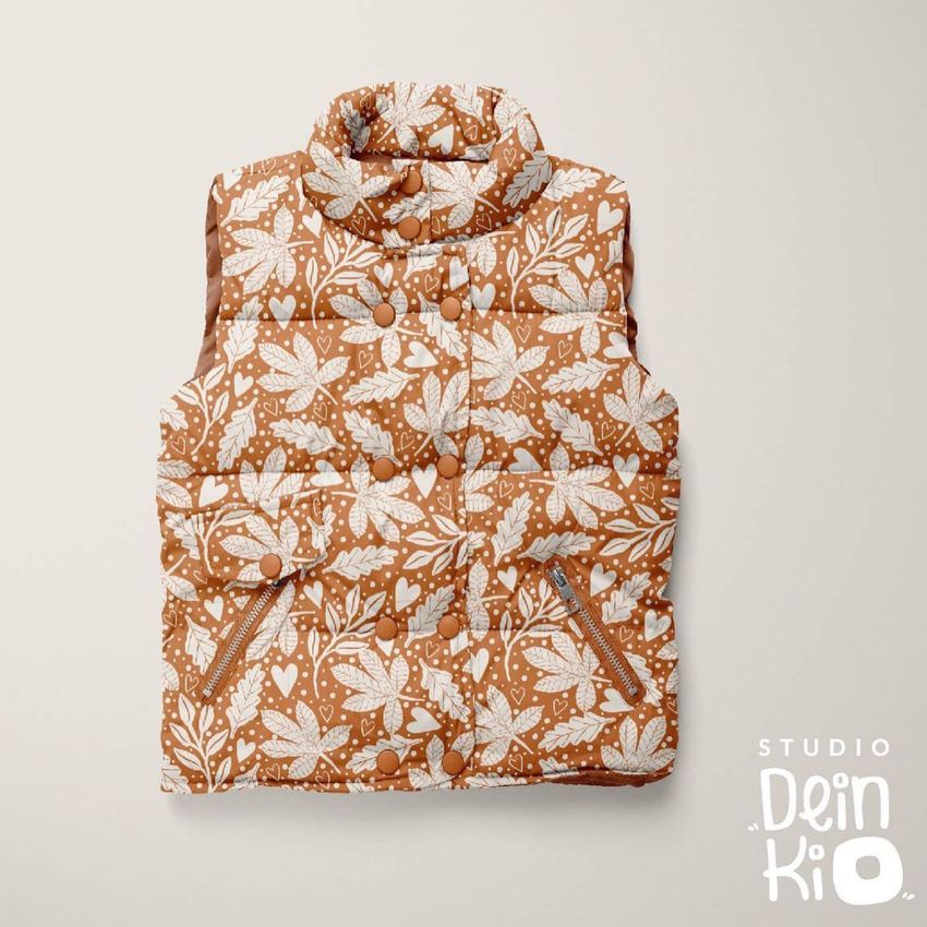 Kids winter vest mockup with a brown and white leaf pattern, shown flat on a light beige background with visible buttons.