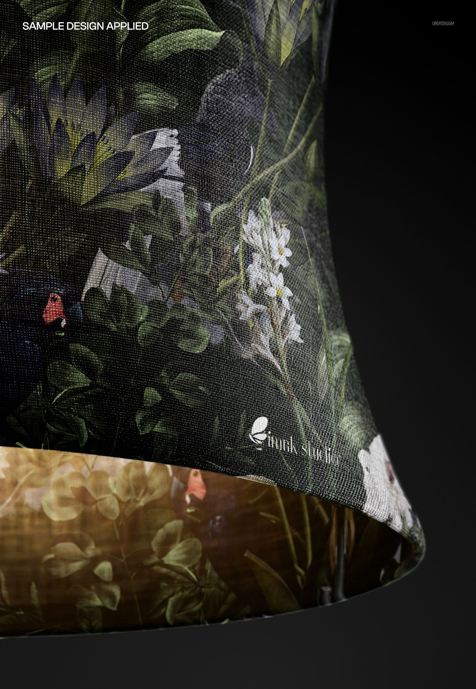 Curved linen lampshade mockup with a close-up view, featuring a detailed floral and foliage pattern on dark fabric.