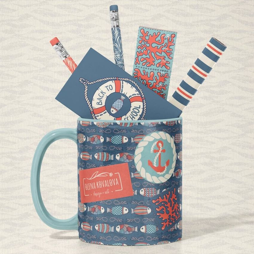 Mug mockup with a blue handle, decorated with nautical patterns, holding pencils and stationery items with matching designs.