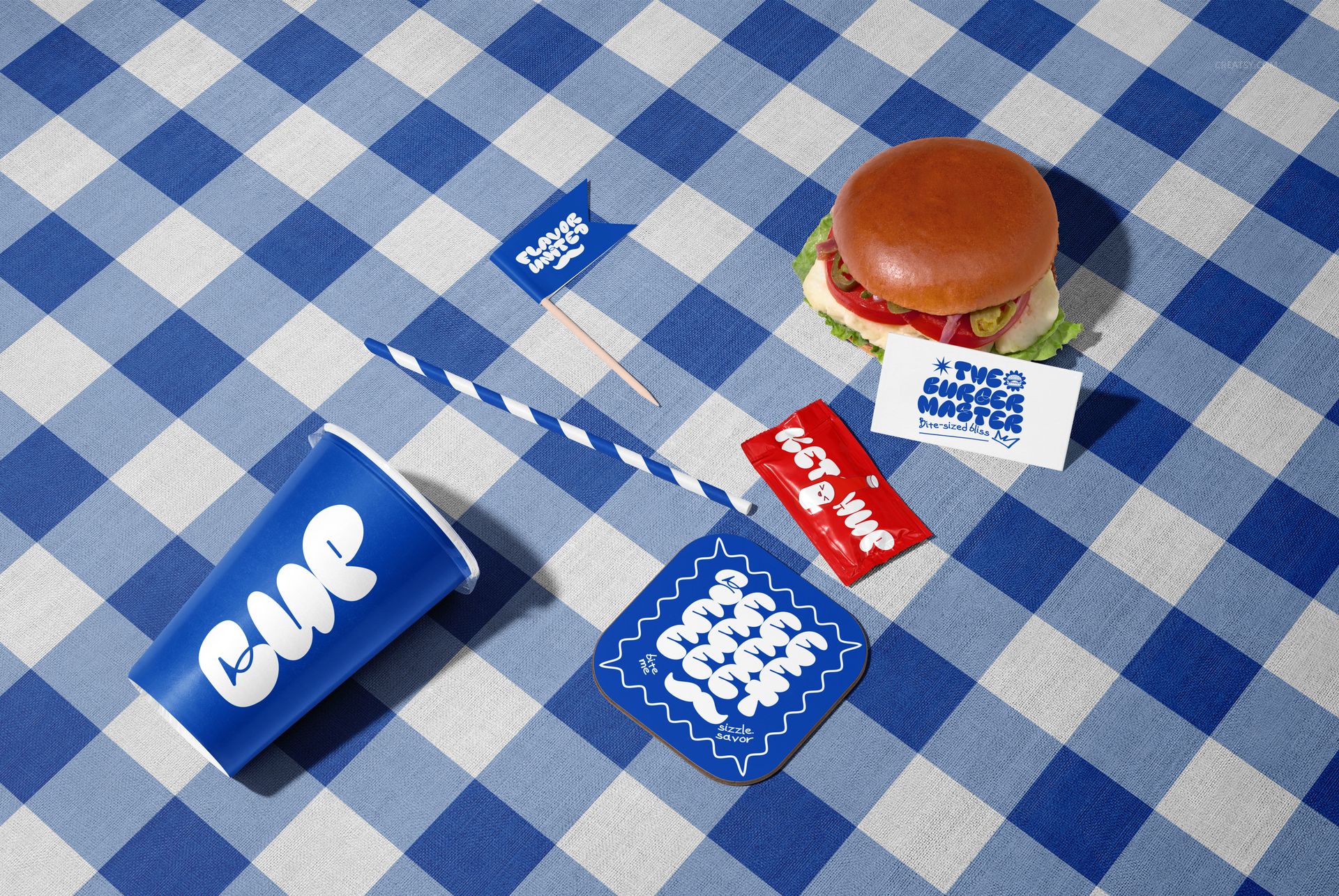 Vegan burger with lettuce and tomato on a blue checkered tablecloth, surrounded by branded packaging mockups.
