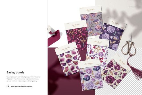 PSD mockup of fabric swatches with various violet and rose patterns, shown from a top view with sewing props nearby.