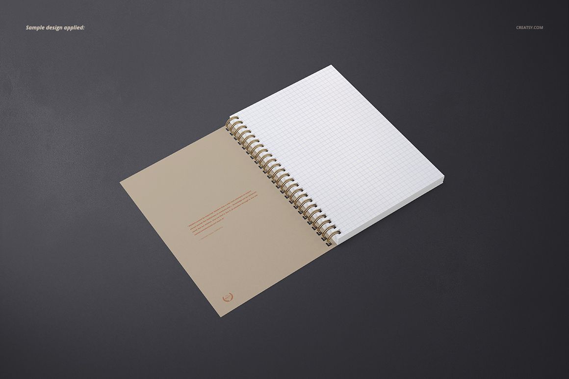 Open A5 spiral notebook mockup displaying white grid pages and a brown inside cover, viewed from above on a dark background.