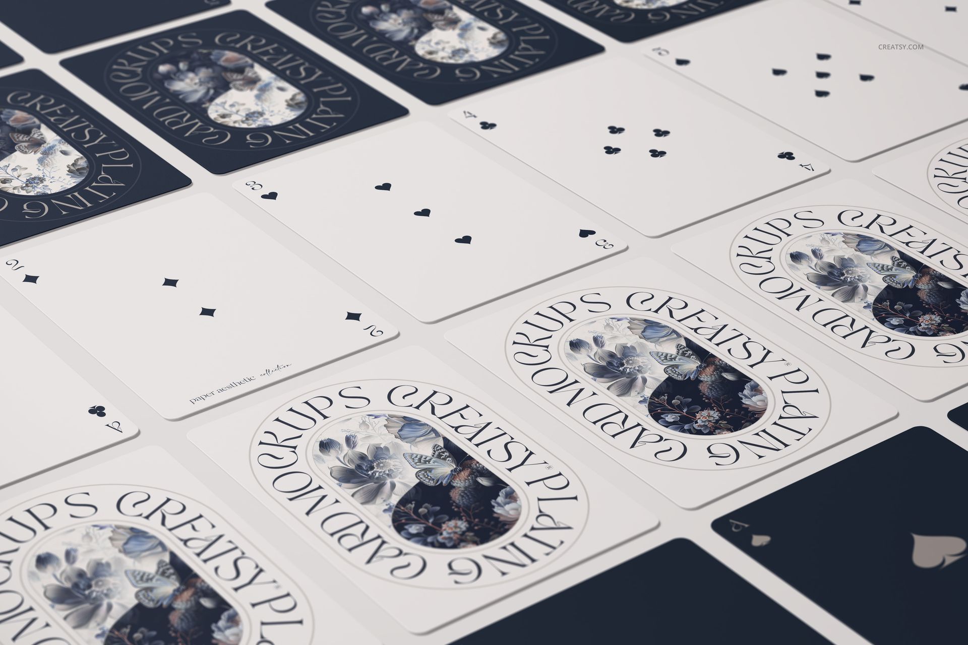 Close-up view of playing cards mockup set featuring spade suit faces and illustrated backs with floral patterns.