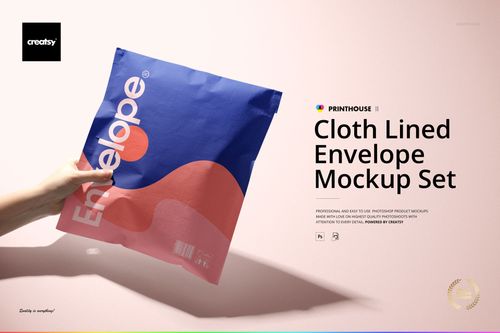 Front view of a cloth lined envelope mockup with blue and pink abstract design, held by a hand on a pale surface.