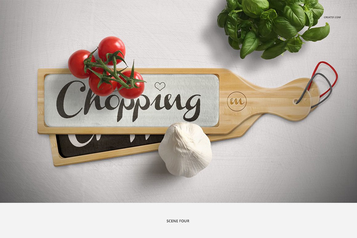 Wooden chopping board mockup with glass insert, displayed from above with tomatoes, garlic bulb, and fresh basil leaves.