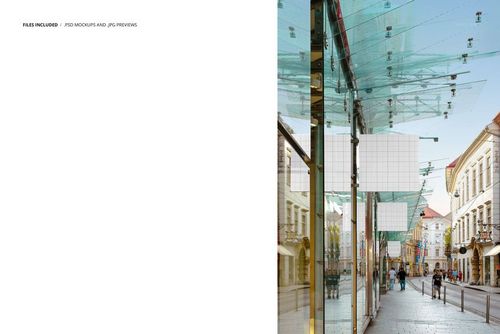 PSD mockup showing a European outdoor walkway lined with reflective glass panels and empty square signboards.