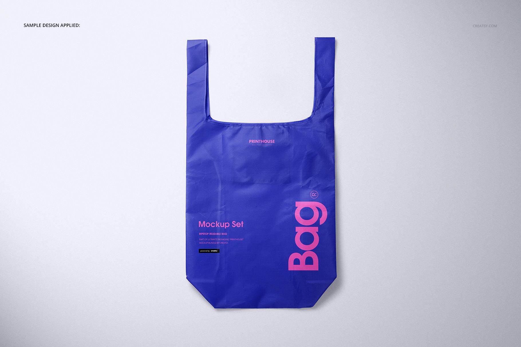 Blue ripstop reusable bag mockup shown flat from above, featuring bold pink lettering and a simple backdrop.