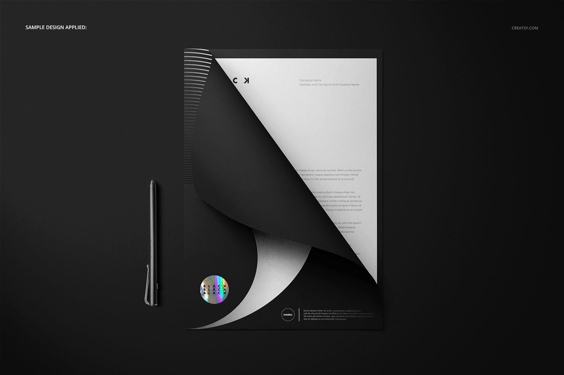Folder mockup featuring a black and white folder with a curved page corner, pen on the left, viewed from above.
